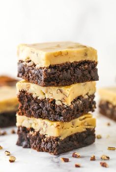 three brownies stacked on top of each other with peanut butter frosting and chocolate chips