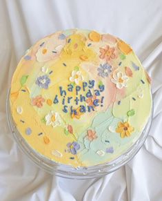 a birthday cake is decorated with flowers and words