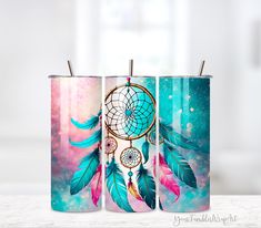 three coffee mugs decorated with colorful feathers and dream catchers on them, sitting on a table