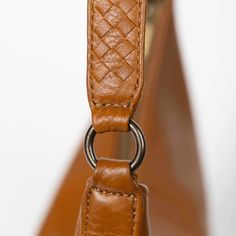 Make a bold statement with this handmade Saddle Shoulder bag in honey, crafted from the highest quality soft and supple genuine leather. Its classic hue adds a touch of elegance to any fall outfit, while the striking woven strap provides a modern edge. Handcrafted in Haiti, this limited production item is a testament to our commitment to sustainable fashion. Each piece is unique, showcasing exceptional craftsmanship and meticulous attention to detail. With ample room for your essentials, it effo Modern Leather Baguette Bag For On-the-go, Luxury Baguette Bag With Leather Handles For Everyday Use, Everyday Use Soft Leather Top Handle Baguette Bag, Everyday Use Top Handle Soft Leather Baguette Bag, Classic Woven Leather Shoulder Bag For Travel, Cognac Woven Leather Bag, Leather Baguette Bag With Adjustable Strap And Double Handle, Classic Shoulder Bag With Braided Handles For Everyday, Brown Baguette Bag With Detachable Strap For On-the-go