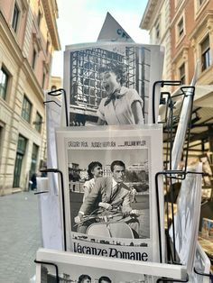 an old movie poster is on display in the street