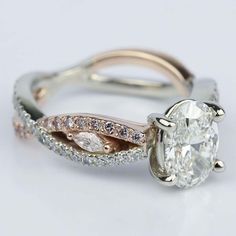 a close up view of a ring with a diamond in the middle and an oval shaped center