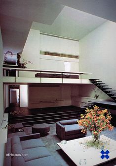 a living room filled with furniture and a staircase