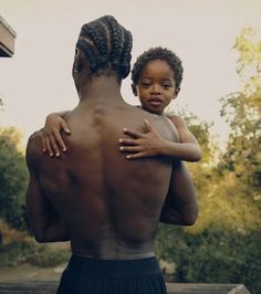 a man holding a small child in his arms