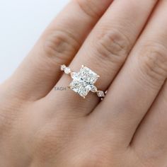 a woman's hand with a diamond ring on it