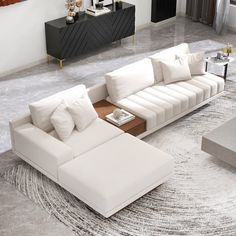 a modern living room with white couches and large rug on the floor, including a coffee table