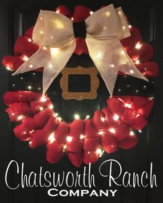 a christmas wreath with lights on it and the words chatsworth ranch company