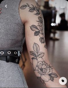 a woman with a flower tattoo on her arm