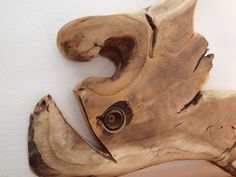 a piece of wood that has been carved into the shape of a bird's head