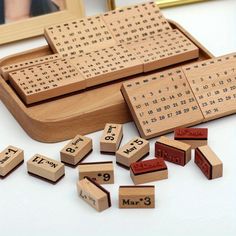 several wooden scrabbles and numbers on a table next to a framed photo