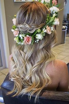 a woman with long blonde hair wearing a flower crown