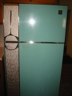 a blue refrigerator freezer sitting inside of a kitchen