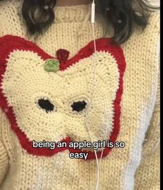 a girl wearing an apple sweater with headphones in her ears and the caption reads, being an apple girl is so easy