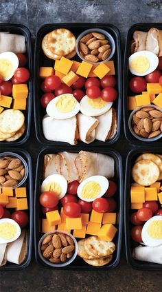 four trays filled with different types of food