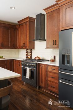 a kitchen with wooden cabinets and stainless steel stove top oven in the center of the room