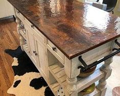 a kitchen island made out of an old cabinet and some wood on the counter top