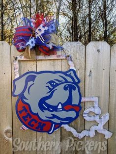 a wooden fence with a sign on it that says, south carolina bulldogs and is decorated with an image of a bulldog's head