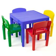 three children's plastic chairs and a table with different colors on the top one