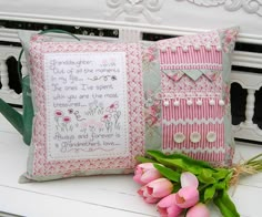 two pillows with flowers on them and one has a cross - stitch pattern in the middle