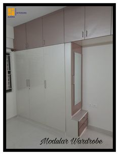 an empty room with some cabinets and drawers on the wall in front of it,