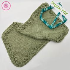 a green knitted baby blanket and matching hair combs