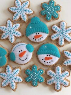 decorated cookies with snowman and snowflakes on them are displayed for the camera