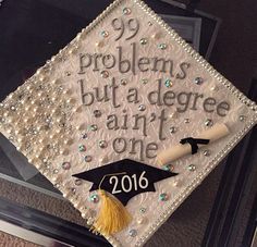 a decorated graduation cap with the words 99 problems but a degree is one on it