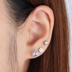 Put a little sparkle in your look with this dazzling gem flower stud! Its concise and elegant design will capture attention like a blooming garden. With a flower thickness of 2mm, you'll certainly be a shining queen. Detail： -Post material: stainless steel -Used in healed piercings. -Tarnish proof and durable so you can wear it everyday without worry! Quantity & Measurement：-Gauge: 16g | 1.2mm-Post length: 6mm-Flower size: 4.2*4.2mm-Flower thickness: 2mm-Include: single item-Hypoallergenic-Closu Silver Crystal Flower Earrings, Sparkling Flower Earrings As Gift, Silver Diamond Flower Earrings With Prong Setting, Silver Sparkling Flower-shaped Earrings, Sparkling Silver Flower-shaped Earrings, Blooming Garden, Ear Style, Daisy Studs, Helix Earrings