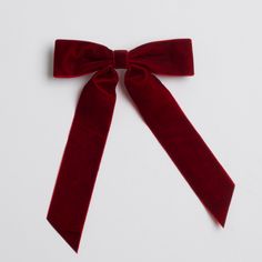 A deep red velvet bow with long, pointed tails and a plush texture. Bow Clip, Velvet Bow, Bow Clips, Velvet Fabric, Deep Red, Christmas Outfit, Red Velvet, The Holiday, Classic Design