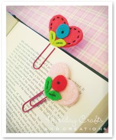 two colorful hair clips sitting on top of an open book