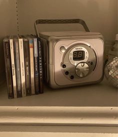 a radio sitting on top of a shelf filled with books