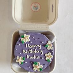 a birthday cake in a box with the words happy birthday kookie written on it