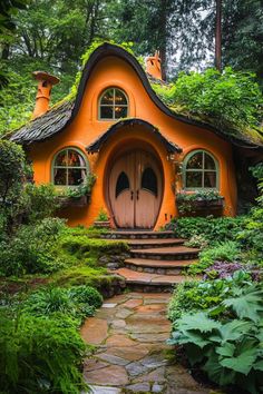 an orange hobbot house in the woods with steps leading up to it's entrance