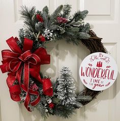 a christmas wreath on the front door with a sign that says wonderful time to go