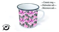 a coffee mug with pink flowers and zebra stripes on the bottom is shown in front of a white background