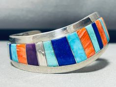 MAKE US AN OFFER BY CLICKING THE "MESSAGE SELLER" Button- This is a wonderful vintage Navajo inlaid waving cuff silver bracelet. This incredible bracelet contains a remarkable inlaid thick and sturdy waving cuff. The way the artist beautifully waved the cuff from one end to the other is just stunning. Inlaid into the cuff are stunning stones and shells that consist of lapis, charoite, red spiny oyster and Sleeping Beauty turquoise. The cuff is very thick and wide and sturdy.  The width of the br Adjustable Multicolor Inlay Bracelets, Southwestern Multicolor Bracelets With Inlay, Spiny Oyster, Vintage Navajo, Sleeping Beauty Turquoise, Bracelet Making, Cuff Bracelets, Native American, Sleeping Beauty