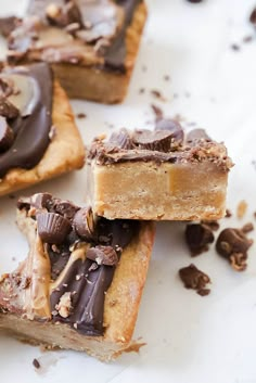 chocolate and peanut butter bars are stacked on top of each other with one bite taken out