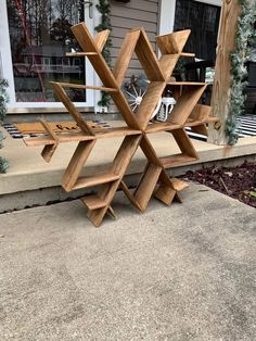 a wooden snowflake sitting on top of a cement ground next to a building