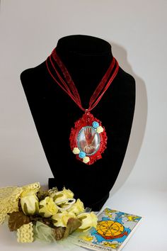 "The Heart in Hand or Heart-in-Hand is a symbol of a heart in an open palm, and is symbolic of charity, given from the heart. Framed oval red 'heart in hand' cameo on a 18\" triple cord and chiffon ribbon necklace with lobster clasp closure. Pendent measures 3\" by 2\" and is adorned with permanent crystal rhinestones and roses." Gothic Pendant, Black Dahlia, Ribbon Necklace, Red Heart, Crystal Rhinestone, Necklace Etsy, Necklace Lengths, Jewelry Necklace Pendant, Handmade Items