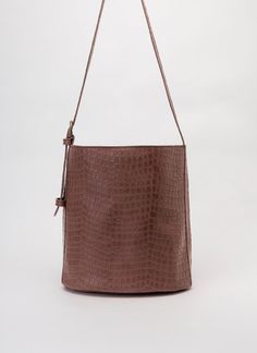 This leather bucket bag, carefully handmade in aour atelier, is perfect for those who seek elegance and practicality.  It's an exclusive dark brown crocodile embossed leather bucket purse that combines style and functionality.  The cow leather, embossed to mimic crocodile skin, offers a luxurious look making the bag a great gift for her. KEY FEATURES Perfect Gift:  Ideal for any special occasion, this dark brown crocodile embossed leather bucket bag is a thoughtful gift for anyone who values qua Waist Bag Leather, Bucket Purse, Leather Waist Bag, Fur Bag, Metallic Bag, The Cow, Brown Handbag, Crocodile Skin, Leather Bucket Bag