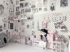 a room filled with lots of pink and white decorations on the wall above a desk