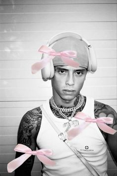 a man with headphones and pink bows around his neck