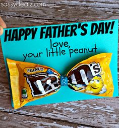 someone holding up a happy father's day candy bar