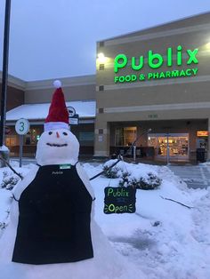 a snowman is in front of a publix pharmacy