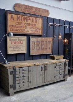 an old wooden cabinet with metal drawers and signs on the wall above it that says woodblog my industrial interior