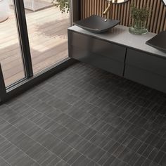 a bathroom with two sinks and a large glass door leading to an outside patio area