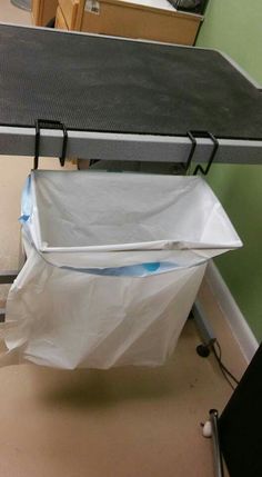 an ironing board on top of a table next to a plastic bag