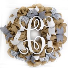 a monogrammed burlock wreath with the letter d on it and ribbon