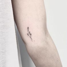 a single flower tattoo on the left arm