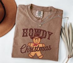 Howdy Holidays Shirt, Western Christmas Sweater, Cowgirl Christmas Shirt, Cowboy Christmas Shirt, Howdy Country Christmas Shirt, Gingerbread We design trendy sweatshirts that you can use in every important day of your life. We produce beautiful and quality designs that can be used in all kinds of activities that you will do with your family or friends. These designs will offer you and your environment a unique complement. We are very excited to bring you our high quality and soft, trendy sweatsh Western Christmas Sweatshirt, Christmas Tee Shirts Western, Country Christmas Shirts, Cowgirl Christmas, Trendy Sweatshirts, Cowboy Christmas, Western Christmas, Bee Design, Country Christmas